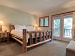 Spacious Master Bedroom with Jetted Tub in Bathroom and Sliding Doors to Large Covered Deck